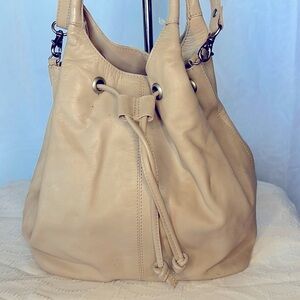 CROSSING POINTE Vintage bone colored genuine leather bucket style handbag.